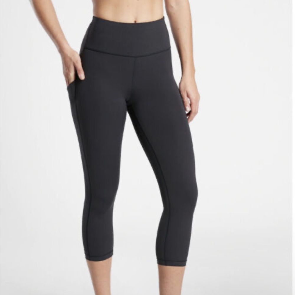 Athleta Salutation stash pocket Capri Black leggings.